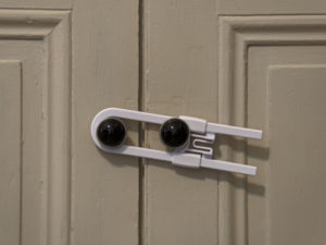Close up of a baby lock securing cabinet doors in Conroe Texas