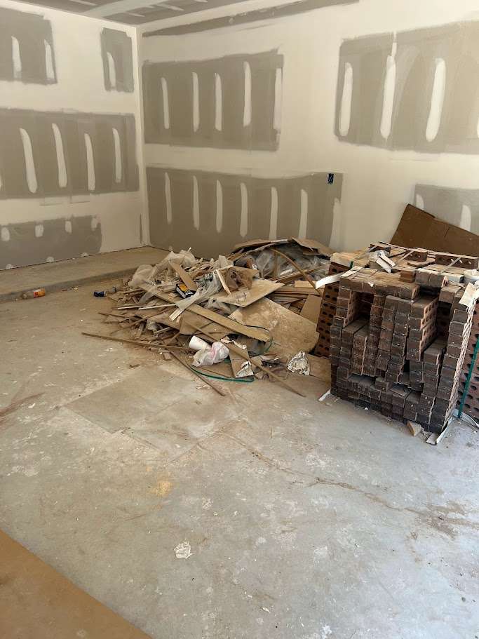 Construction debris loaded into a Conroe dumpster rental